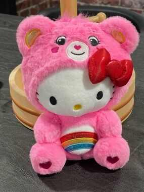 Hello Kitty wearing a Pink Plush Care Bear Costume with Rainbow Belly